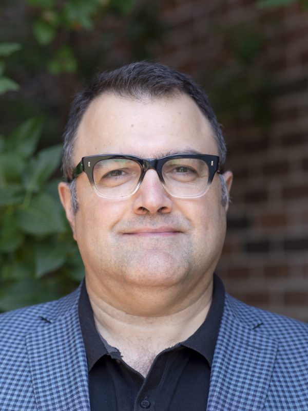 Profile picture of Dr. Farzad Zare-Bawani, wearing glasses and in a blue checkered blazer